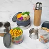 Several food containers and a water bottle are arranged on a marble surface. Podgląd zdjęcia produktu