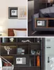 A collage of images showing safes in various settings, including a wall, a side table, and a bookshelf. Produktbild-Vorschau