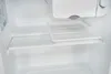 Inside view of an empty refrigerator with a shelf and a plastic tray. Produktbild-Vorschau