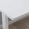 A close-up view of a white desk with a wooden floor. Anteprima dell’immagine prodotto
