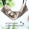 A cat sleeping in a leopard-print hammock. Produktbild-Vorschau