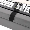 Close-up of a bed frame with a grey fabric skirt and a black strap. Produktbild-Vorschau