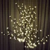 A decorative LED tree with warm white lights against a curtain background. Produktbild-Vorschau