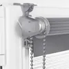 A close-up view of a roller blind mechanism attached to a window frame. Produktbild-Vorschau