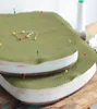Two layered foam pads covered with green fabric and secured with pins, suggesting a DIY upholstery or crafting project. Produktbild-Vorschau