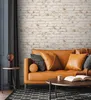 A living room scene with a sofa, coffee table, and side table. Produktbild-Vorschau