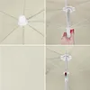 Collage of four close-up images showing different parts of a beige umbrella, including the canopy, the central mechanism, and a hand operating the umbrella. Voir les images du produit