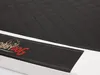 A close-up view of a dog bed with a quilted black top and a black side band featuring a logo. Produktbild-Vorschau