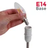 A hand is holding a light bulb and is about to insert it into a lamp socket. Podgląd zdjęcia produktu