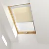 A skylight window with a beige roller blind partially covering it. Produktbild-Vorschau