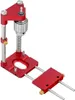 A red and silver adjustable woodworking drill locator on a white background. Náhled obrázku produktu