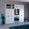 A white wardrobe with mirrored doors in a room. Produktbild-Vorschau