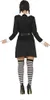 A person wearing a black dress and striped socks, viewed from the back. Produktbild-Vorschau