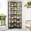 A corner shelf unit filled with potted plants on a balcony or patio. Náhled obrázku produktu