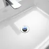 A close-up shot of a white sink with a chrome faucet and a decorative pop-up drain. Produktbild-Vorschau