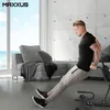 A man is exercising on a fitness device in a modern living room with a view of the ocean. Produktbild-Vorschau