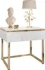 A white high-gloss nightstand with a gold frame and decorative elements on top. Náhled obrázku produktu