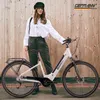 A woman stands next to a white e-bike in front of a wooden wall. Produktbild-Vorschau