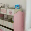 A close-up view of a children's storage shelf with fabric bins and toys. Náhľad obrázku produktu