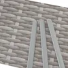 A close-up view of three light gray poles against a textured gray background that resembles rattan. Produktbild-Vorschau