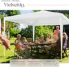 A family is enjoying a meal under a white gazebo in a garden. Náhled obrázku produktu