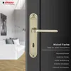A close-up of a nickel-colored door handle on a dark gray door, with a blurred interior scene in the background. Anteprima dell’immagine prodotto