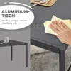 A hand is wiping a dark gray aluminum garden table with a yellow cloth. Water droplets are visible on the table surface. A smaller image of the table is shown on the left. Produktbild-Vorschau