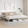 A white metal bed frame with bedding in a bedroom setting. Produktbild-Vorschau