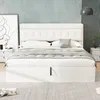 A bedroom scene featuring a white bed with a tufted headboard. Anteprima dell’immagine prodotto