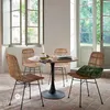 A dining set with a round wooden table and four wicker chairs in a bright room with large windows. Podgląd zdjęcia produktu