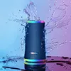A black Bluetooth speaker with colorful LED lights is shown with water splashing around it. Produktbild-Vorschau