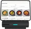 A tablet displaying a recipe finder app is docked on a smart kitchen device. Produktbild-Vorschau