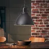 A black pendant light hangs over a wooden dining table with a bowl and cutlery. Produktbild-Vorschau