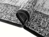 A close-up view of a rolled-up rug, showing the texture and edge binding. Náhled obrázku produktu