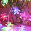 A close-up of colorful snowflake-shaped LED lights. Produktbild-Vorschau