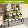 A multi-tiered plant stand filled with various potted plants, placed indoors near a window with sunlight streaming in. Podgląd zdjęcia produktu