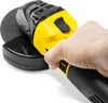 A hand holding a yellow and black angle grinder with a spinning disc. Produktbild-Vorschau