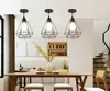 A dining room with a wooden table and chairs, illuminated by three pendant lights. Náhľad obrázku produktu