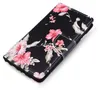 A black flip phone case with a floral hibiscus pattern. Produktbild-Vorschau