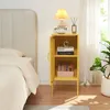 A yellow nightstand next to a bed in a bedroom. Anteprima dell’immagine prodotto