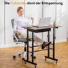 A woman sits at a height-adjustable desk with a laptop and a cup of coffee. Anteprima dell’immagine prodotto