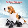 A stuffed dog wearing boots in a snowy environment. Náhled obrázku produktu