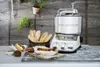 A kitchen scene with a stand mixer, hot dogs, and bread. Anteprima dell’immagine prodotto