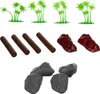 A collection of toy accessories including palm trees, logs, and rocks, arranged on a white background. Anteprima dell’immagine prodotto