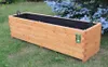 A wooden planter box sits on grass with a blue spruce tree in the background. Produktbild-Vorschau