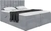 A studio shot of a gray upholstered box spring bed with a headboard, mattress, and topper. A dark gray blanket is draped over the bed. Produktbild-Vorschau