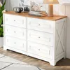 A white and wood dresser with six drawers is shown in a room setting, with a plant and decor on top. Anteprima dell’immagine prodotto