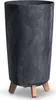 A tall, cylindrical planter with a dark gray, marbled texture and three light brown wooden legs. Náhľad obrázku produktu