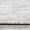 Close-up view of the texture and edge of a light-colored rug. Anteprima dell’immagine prodotto