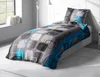 A neatly made bed with a duvet and pillow, set in a room with a window and a floor lamp. Produktbild-Vorschau